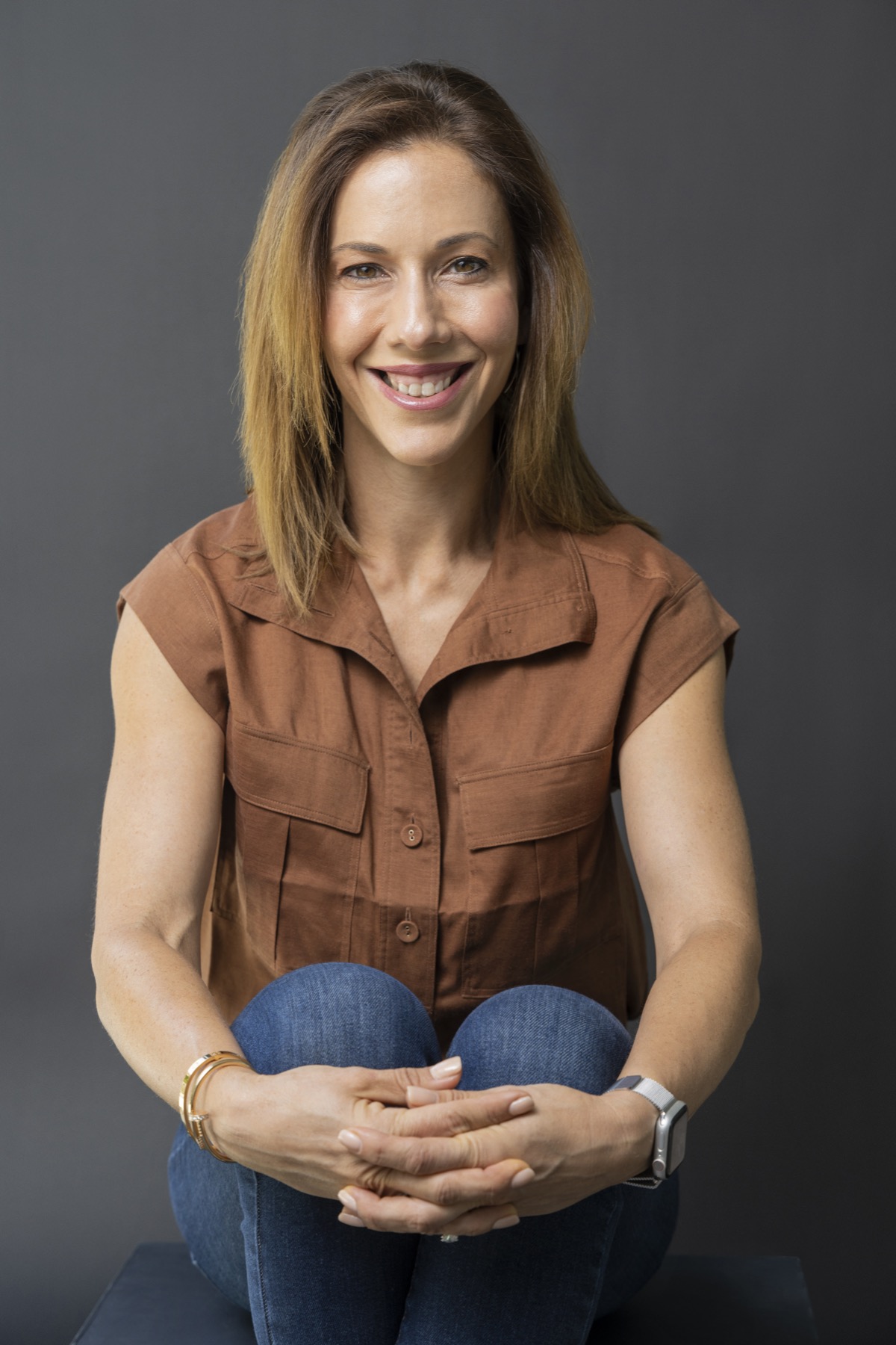 Martine Prunty smiling, seated with her hands clasped