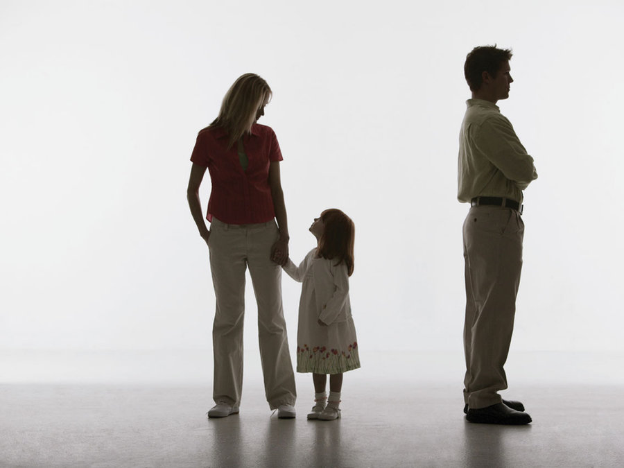 A child standing between two parents