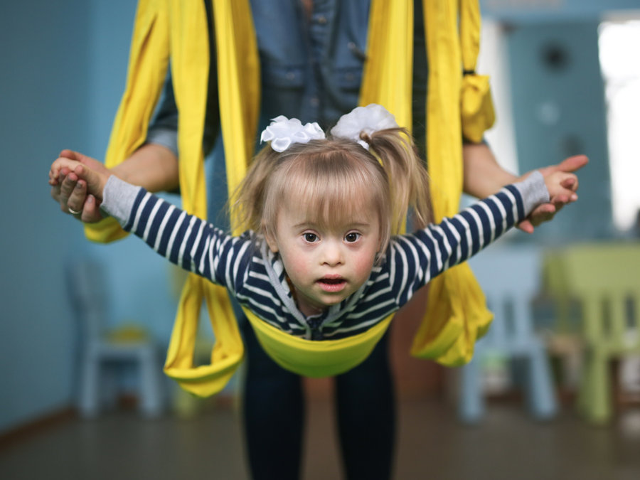 A child supported in a therapy swing