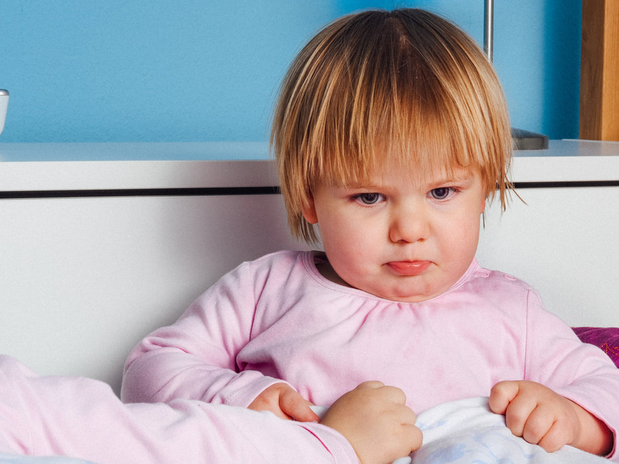 A young child with folded arms